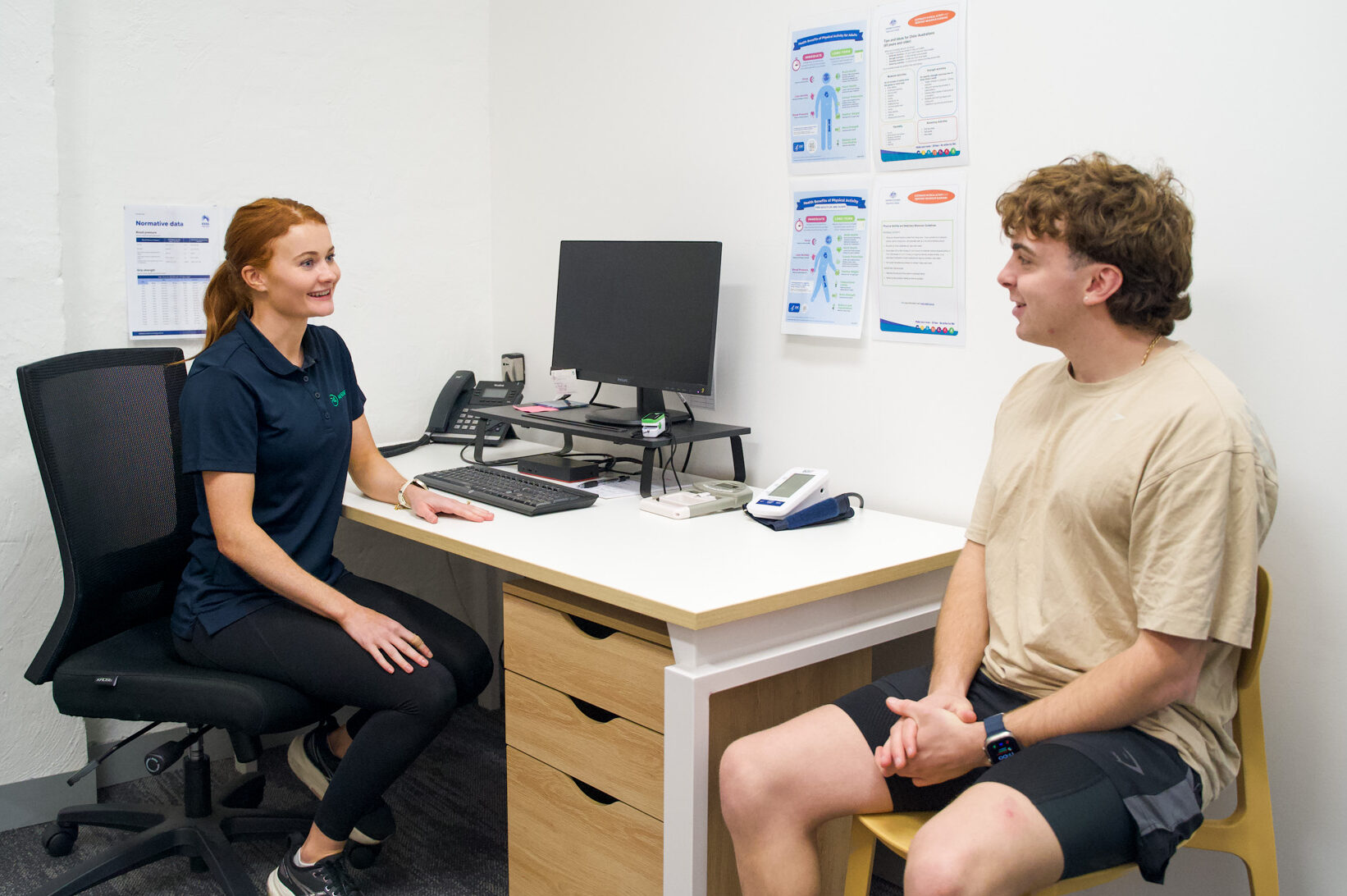 Man and P4 Movement Physiotherapist discussing whether posture is causing him pain at P4 Movement in Wollongong
