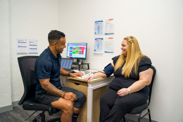 P4 Movement Exercise Physiologist taking the blood pressure of a client